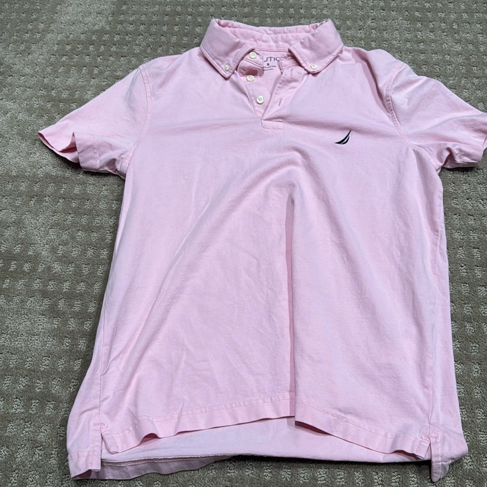 Pink polo collared short sleeve shirt.